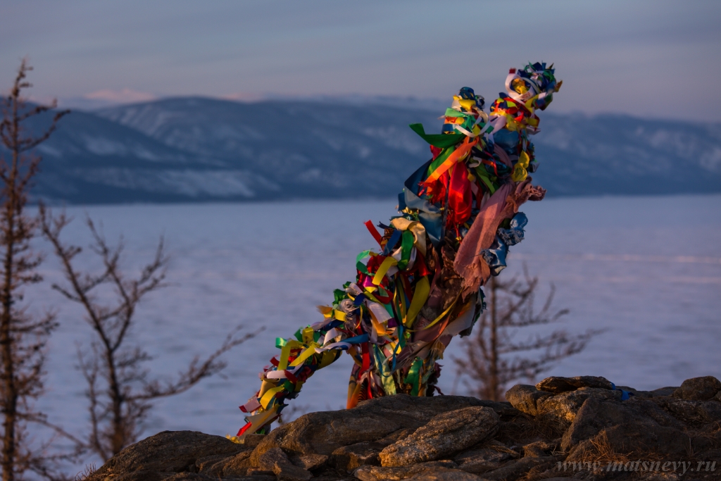 D04B7382.JPG - Colored ritual ribbons tied on the tree and wooden poles as a buddhist tradition on Baikal lake.