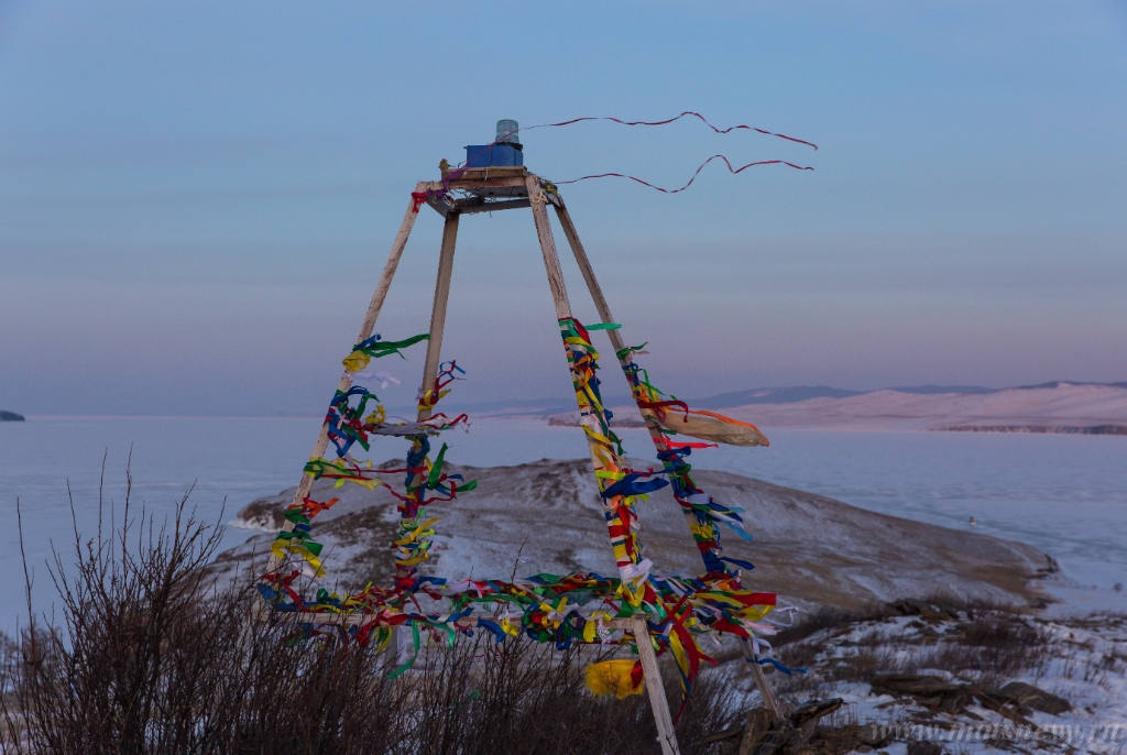 D04B7399.JPG - Colored ritual ribbons tied on the tree and wooden poles as a buddhist tradition on Baikal lake.