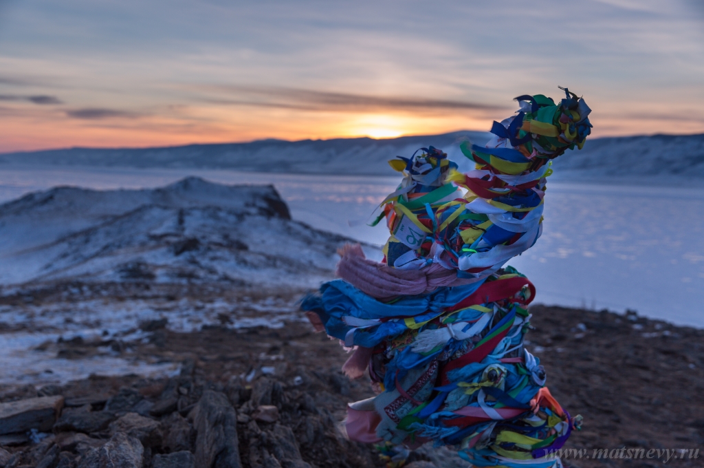 D04B7432.JPG - Colored ritual ribbons tied on the tree and wooden poles as a buddhist tradition on Baikal lake.