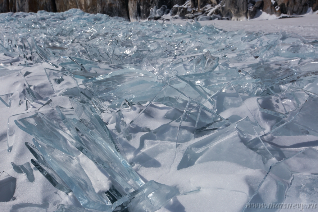 D04B7701.JPG - Scenic winter lake Baikal landscape with pressure ridge transparent ice blocks on the surface.