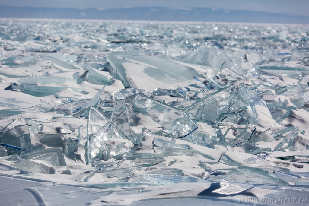 D04B7778.JPG - Scenic winter lake Baikal landscape with pressure ridge transparent ice blocks on the surface.
