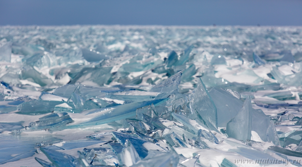 D04B7797.JPG - Scenic winter lake Baikal landscape with pressure ridge transparent ice blocks on the surface.
